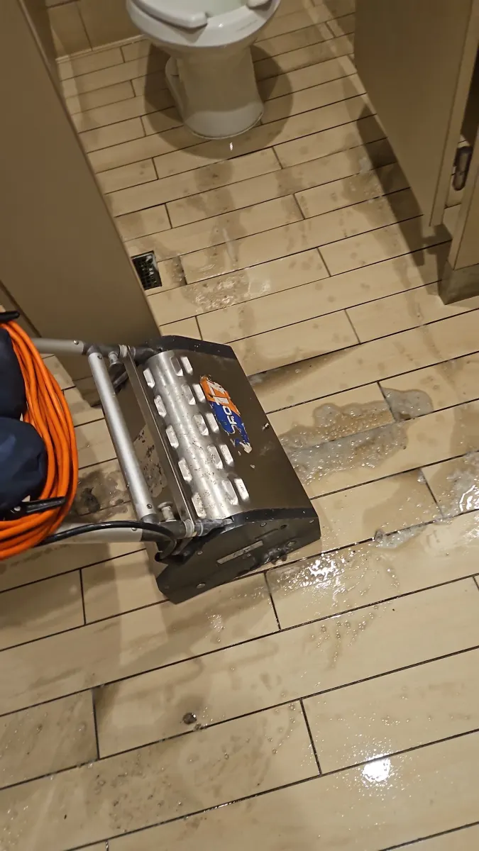Tile and grout scrubber in a bathroom Tile and grout scrubber in a bathroom