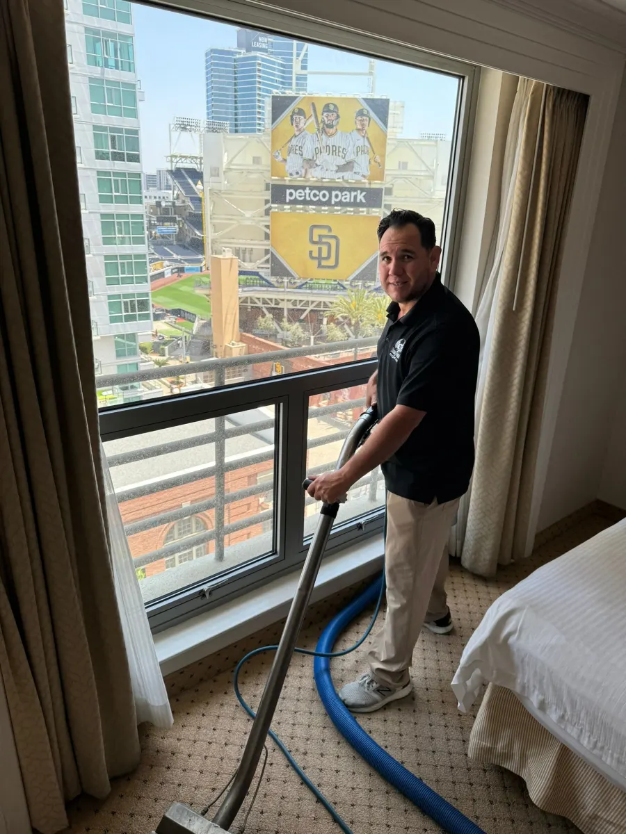Technician cleaning hotel room carpet in downtown San Diego Technician cleaning hotel room carpet in downtown San Diego
