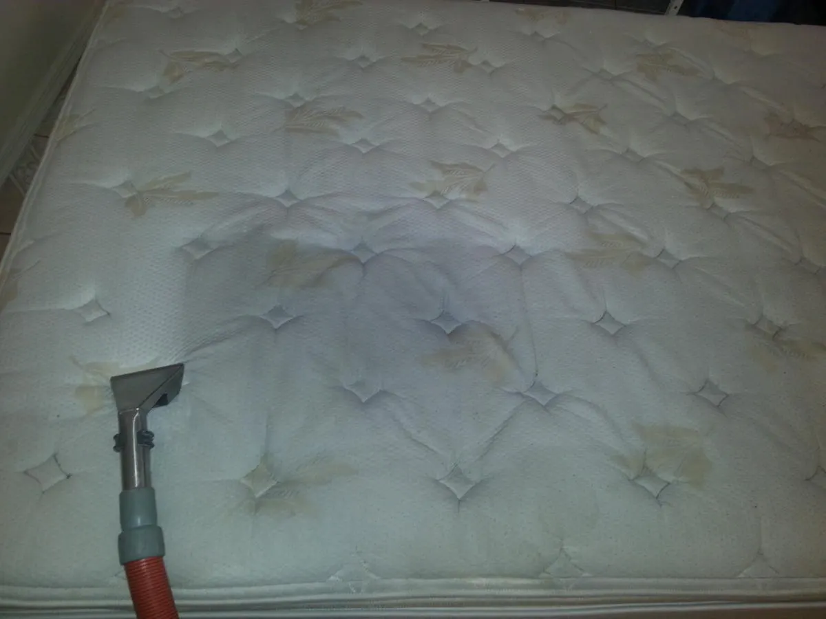 Mattress being deep cleaned with upholstery tool Mattress being deep cleaned with upholstery tool