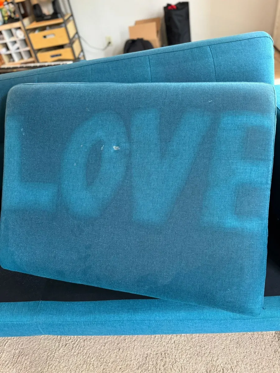 βLOVEβ cleaned into a teal sofa cushion βLOVEβ cleaned into a teal sofa cushion