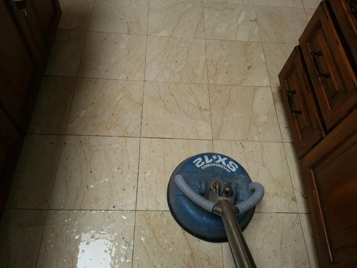 Tile floor being cleaned with a spinner tool Tile floor being cleaned with a spinner tool