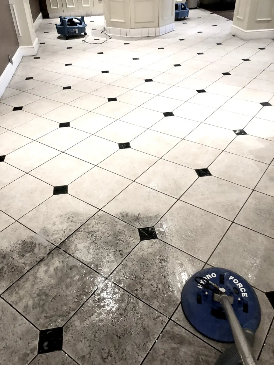 Spinner tool cleaning a white tile floor, cleaned vs. uncleaned area Spinner tool cleaning a white tile floor, cleaned vs. uncleaned area